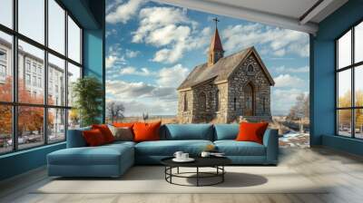 Old stone church stands on the prairie on a winter day with a bright blue sky and white clouds Wall mural