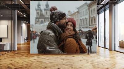 Tourists enjoying winter holidays in prague old town square during snowfall with traditional christmas market in the background Wall mural