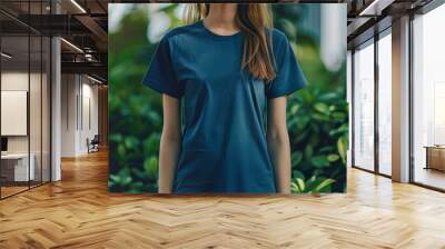 Young woman is wearing a blue t shirt, presenting a great opportunity for your next apparel mockup design Wall mural