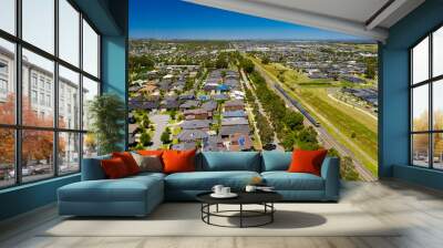 Aerial view of an outer suburb in Melbourne with train passing by Wall mural