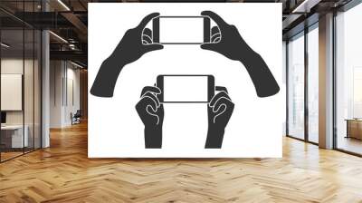 Hands holding phone in horizontal position. Blank screen mobile phone for message or photo. Wall mural