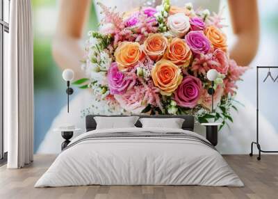 A vibrant wedding bouquet featuring orange and pink roses, ideal for bridal ceremonies and romantic celebrations. Wall mural