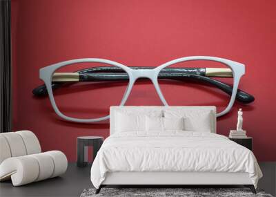 Modern fashionable spectacles on red background, Glasses Wall mural