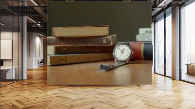 Old vintage watch and some books on a table Wall mural