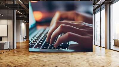 close - up of hands typing on laptop keyboard with internet browser, featuring a black keyboard and a blurry white hand in the foreground Wall mural