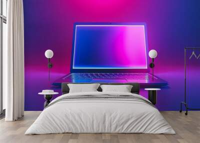 A sleek laptop illuminated with vibrant pink and blue lighting, showcasing modern technology. Wall mural