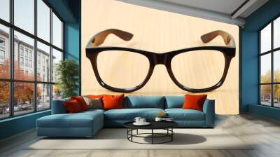 black glasses on wood  background Wall mural