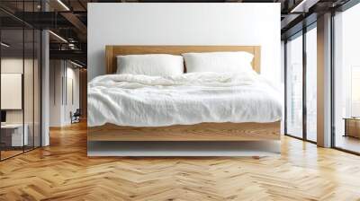 A simple oak bed frame with two white linen pillows and a duvet on it Wall mural