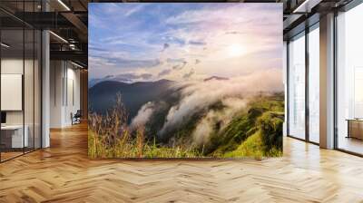 Beautiful landscape nature on peak mountain with sun cloud fog and bright colors of sky and sunlight during sunset in winter at viewpoint Phu Chi Fa Forest Park in Chiang Rai Province, Thailand Wall mural