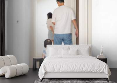 A 1 year old Taiwanese girl spending time playing happily with her parents, a man and woman in their 20s, in a room of a high rise apartment in Taichung City, Taiwan. Wall mural