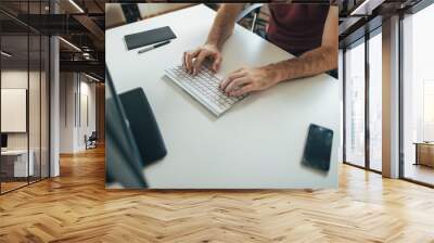 Close up of male hands typing on computer keyboard Wall mural