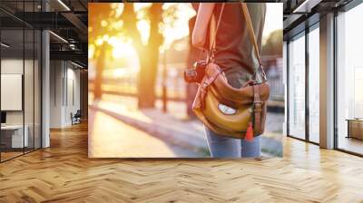 Midsection of female photographer with retro camera
 Wall mural