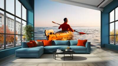 Rear view of senior man enjoy paddling kayak  Wall mural