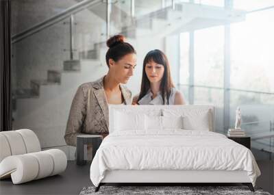 two business women discussing checklist Wall mural