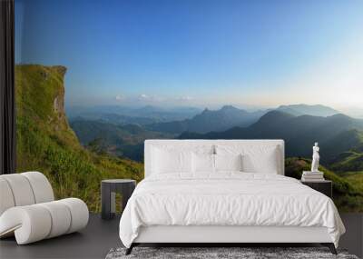 Man traveler on cliff with beautiful landscape sunset at Phu Chi Fa and national forest park in Thailand. Wall mural