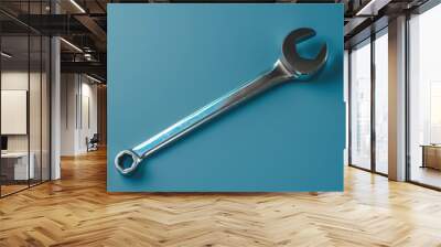 Close-up of a shiny wrench on a blue background in a workshop setting Wall mural