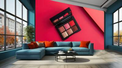 Colorful makeup palette arranged on a vibrant red background Wall mural