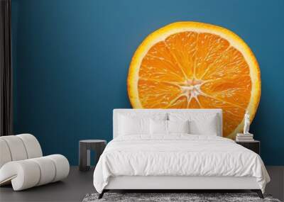 Freshly cut orange slice on a blue background Wall mural