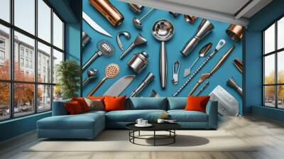 Kitchen utensils arranged on a vibrant blue background for cooking and baking Wall mural