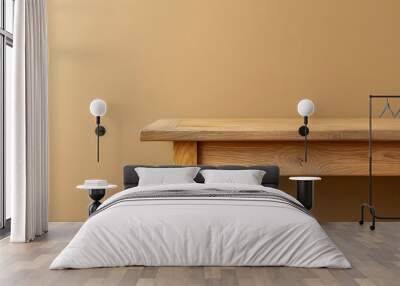 Simple wooden table against a warm beige wall in a natural light setting Wall mural