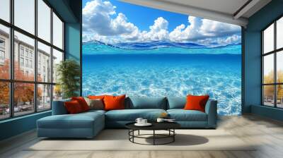 blue water surface reveals a sandy sea bottom bathed in warm sunlight, creating a tranquil and inviting underwater scene perfect for relaxation and nature themes Wall mural