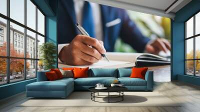 Businessman in suit writes notes, symbolizing professionalism and strategy in corporate settings Wall mural