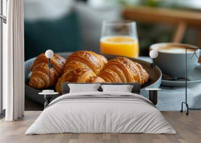 delicious continental breakfast spread featuring freshly baked croissants, a glass of orange juice, a steaming cup of coffee, and fresh fruit, set on a rustic wooden table with natural light Wall mural