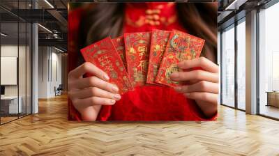 hand holds a red envelope, symbolizing prosperity and good luck for Chinese New Year. The envelope's blank space signifies new opportunities and blessings for the coming year Wall mural