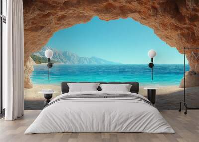 sandy beach framed by rugged rock caves on either side, bathed in warm sunlight. The tranquil scene invites reflection, evoking feelings of peace, solitude, and the timeless beauty of nature Wall mural