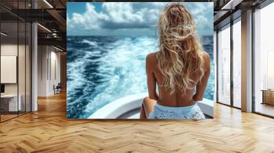 woman in a swimsuit relaxes on a luxury boat, gazing at the serene ocean view from behind. The setting is tranquil and exudes a sense of freedom and escape Wall mural