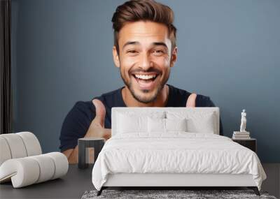 Happy man signaling with thumbs up, isolated on solid light Wall mural