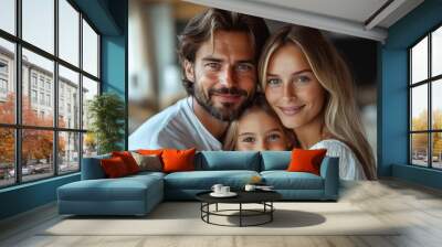 A joyful family of three embraces each other, smiling affectionately in a cozy indoor setting Wall mural