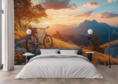 A mountain bike parked under a colorful sunset at beautiful rocky terrain in the countryside Wall mural