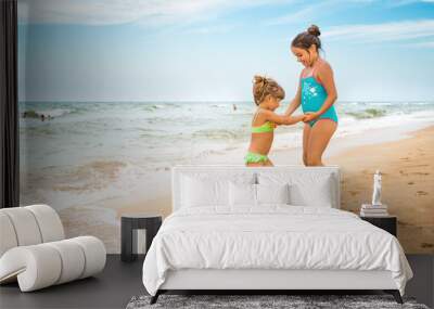 Two charming little girls in swimsuits Wall mural