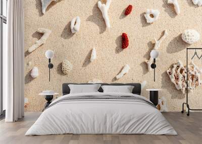 Assorted Seashells and corals on Beige Beach Sand, nature flat lay from shells and white and red coral pieces on natural sandy background, minimal creative pattern, neutral trend tones, above view Wall mural