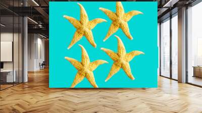 Bright summer pattern with sea stars. Yellow starfish on turquoise, sea summer vacation concept. Wall mural