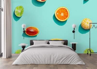 Colorful fruit pattern from fresh citrus, lemon, red orange, tangerine and lime on blue background. Summer food. Wall mural