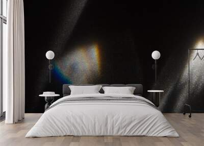 Rainbow light effect from sun flares on black background, colorful glare and shine, light rays on sparkling surface. Rainbow refraction of sunlight. Natural light effects, iridescent colors Wall mural