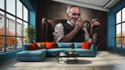 in chair sitting senior business man with cigar and whisky. gray Wall mural