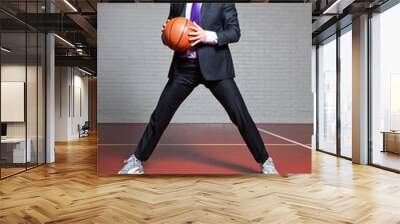 Tough business man with basketball. Wearing dark sunglasses. Wall mural