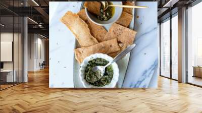 Delicious homemade pastry snacks. Homemade Sourdough Crackers with Pesto & Chimichurri Sauce. Thinly sliced and baked. Great for party, crackling and crunchy goes well with both sauces. Wall mural