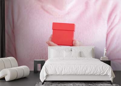 female hands hold a gift box with jewelry Wall mural