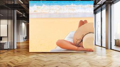 Young woman reads a book on the beach Wall mural