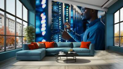 A focused technician works on a data server in a modern data center, surrounded by glowing LED lights and advanced technology. Wall mural