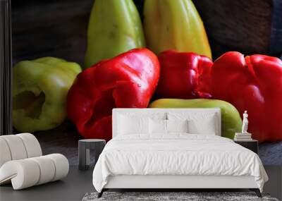 Green and red bell peppers on a rustic table. Wall mural