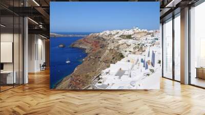 Famous stunning view of white architectures and colors above the volcanic caldera in the village of Oia in Santorini island, Greece Wall mural