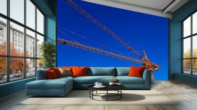 Tower crane arm in the blue sky background Wall mural