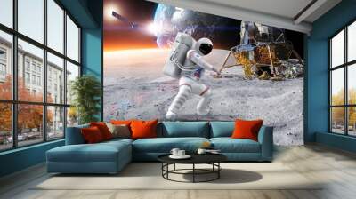 Astronaut Making Kung Fu On Planet Surface. Planet Earth On Background. Wall mural