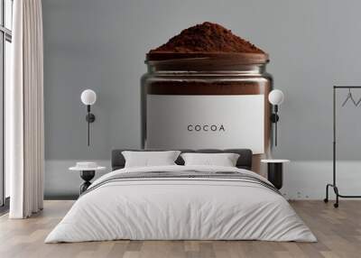 A minimalist, clear glass jar of cocoa powder, isolated with a clean white background, focusing on the rich, deep color of the cocoa inside. Wall mural