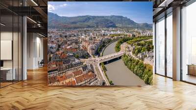 The drone aerial view of the Isère river and Grenoble city, France. Grenoble is the prefecture and largest city of the Isère department in the Auvergne-Rhône-Alpes region. Wall mural